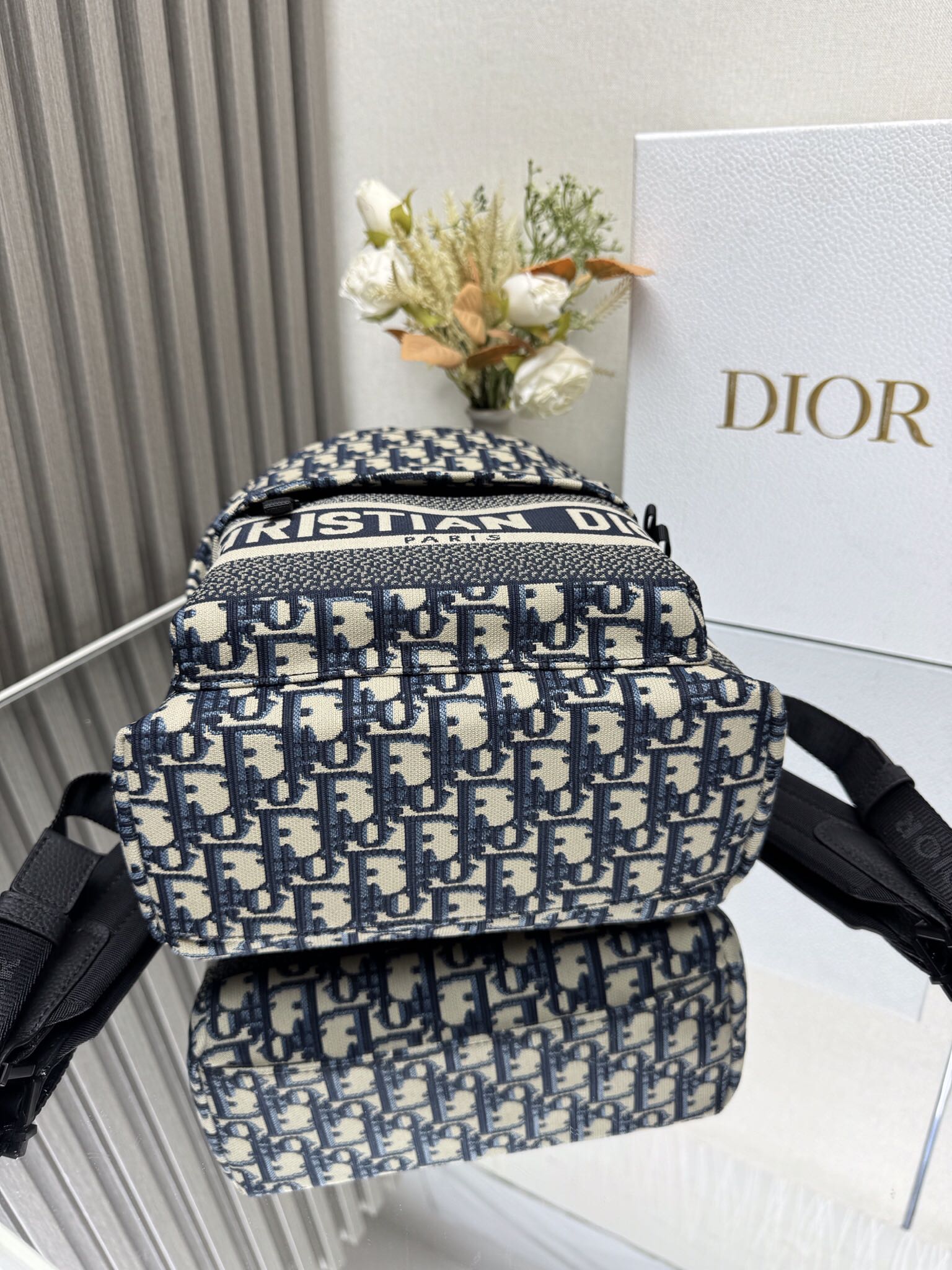 Dior Travel Backpack "Blue Cloth Small" This Travel backpack combines classic details with a stylish and practical design. Crafted from blue jacquard technical fabric, it features an all-over Oblique print and a striking Christian Paris signature on the front Dimensions: 23.5 x 32 x 11 cm (L x H x W) 4 Dior Travel Backpack "Blue Cloth Small" This Travel backpack combines classic details with a stylish and practical design. Crafted from blue jacquard technical fabric, it features an all-over Oblique print and a striking Christian Paris signature on the front Dimensions: 23.5 x 32 x 11 cm (L x H x W) - Image 4