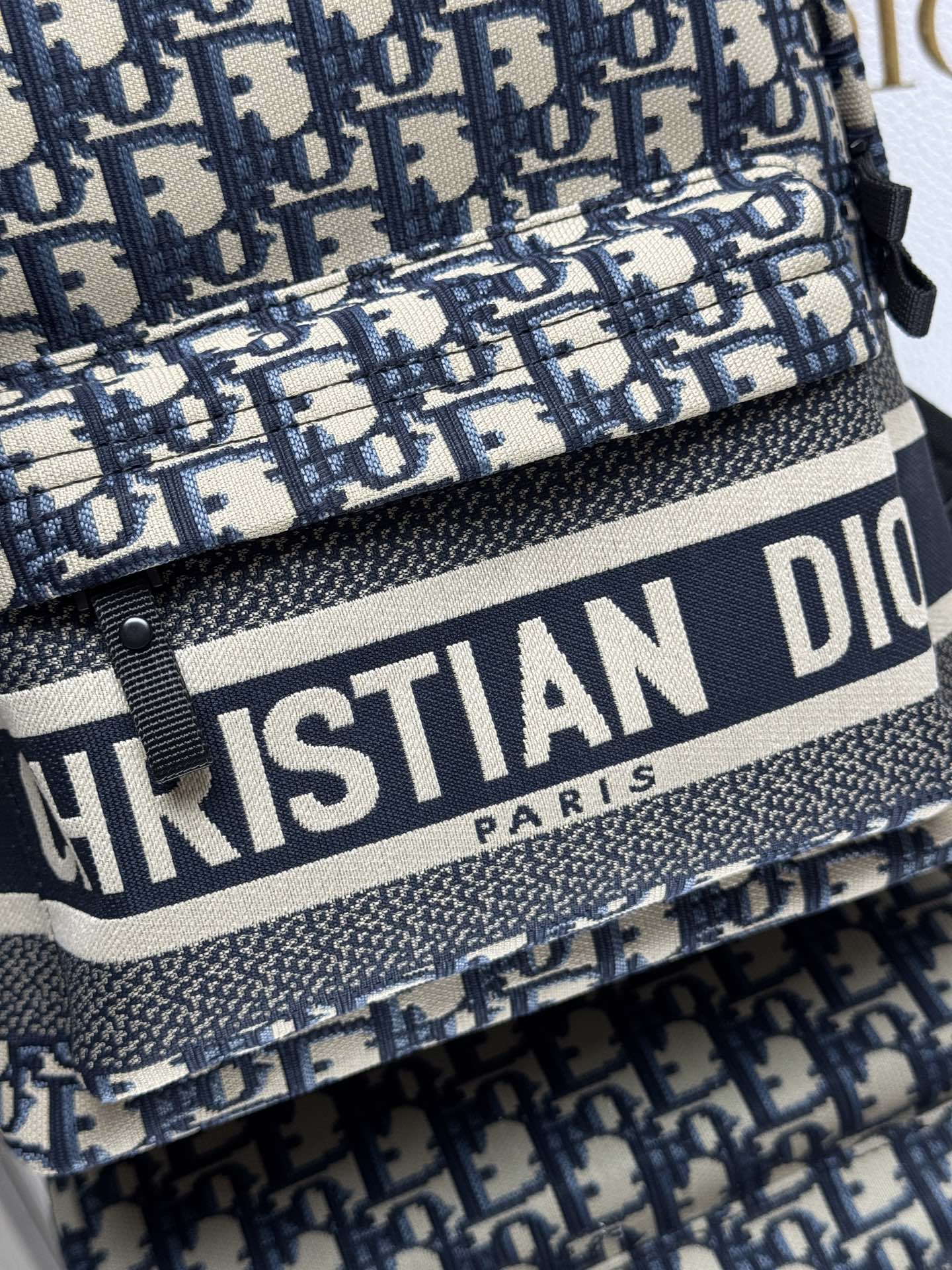 Dior Travel Backpack "Blue Cloth Small" This Travel backpack combines classic details with a stylish and practical design. Crafted from blue jacquard technical fabric, it features an all-over Oblique print and a striking Christian Paris signature on the front Dimensions: 23.5 x 32 x 11 cm (L x H x W) 8 Dior Travel Backpack "Blue Cloth Small" This Travel backpack combines classic details with a stylish and practical design. Crafted from blue jacquard technical fabric, it features an all-over Oblique print and a striking Christian Paris signature on the front Dimensions: 23.5 x 32 x 11 cm (L x H x W) - Image 8