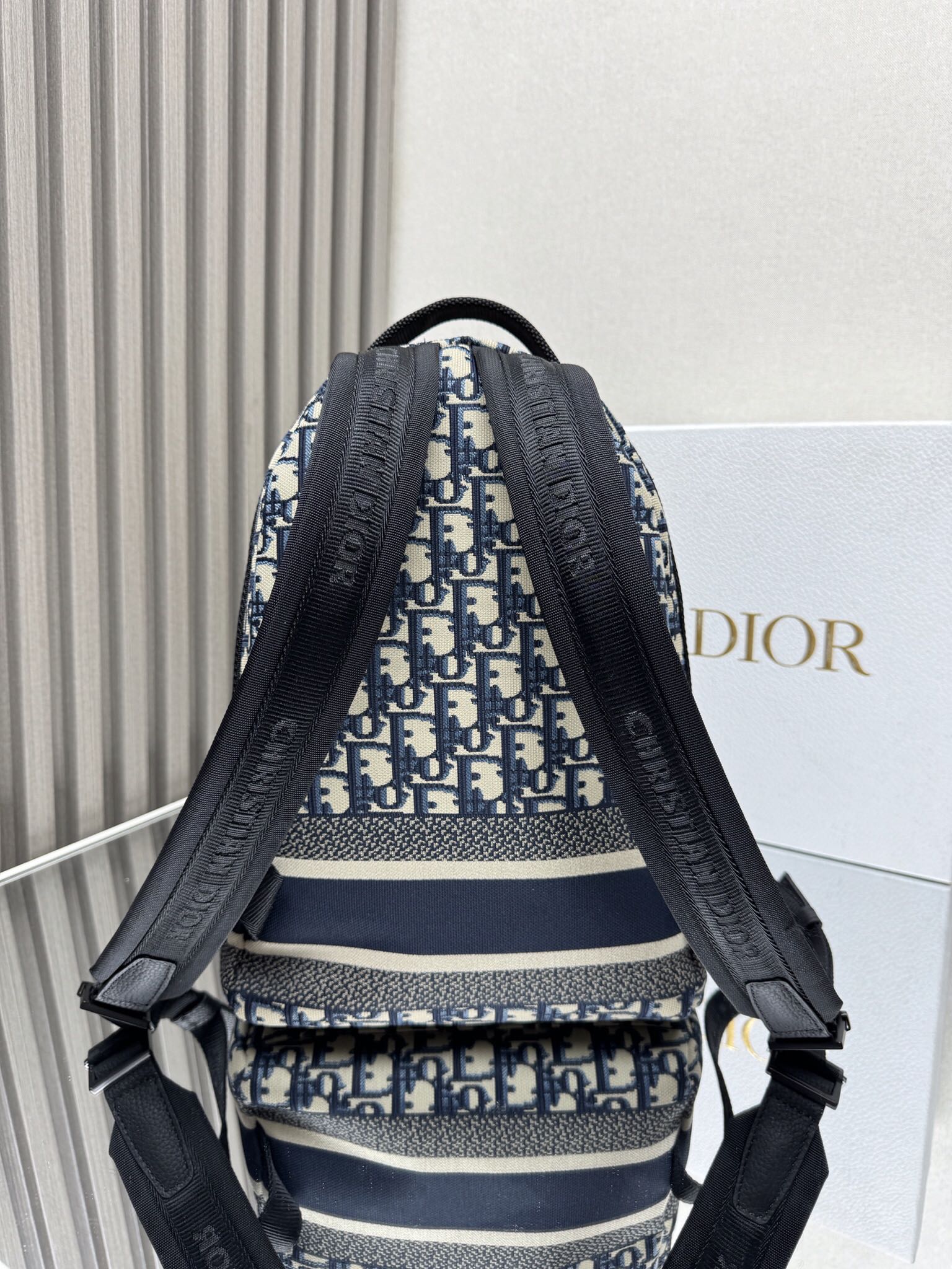 Dior Travel Backpack "Blue Cloth Small" This Travel backpack combines classic details with a stylish and practical design. Crafted from blue jacquard technical fabric, it features an all-over Oblique print and a striking Christian Paris signature on the front Dimensions: 23.5 x 32 x 11 cm (L x H x W) 6 Dior Travel Backpack "Blue Cloth Small" This Travel backpack combines classic details with a stylish and practical design. Crafted from blue jacquard technical fabric, it features an all-over Oblique print and a striking Christian Paris signature on the front Dimensions: 23.5 x 32 x 11 cm (L x H x W) - Image 6