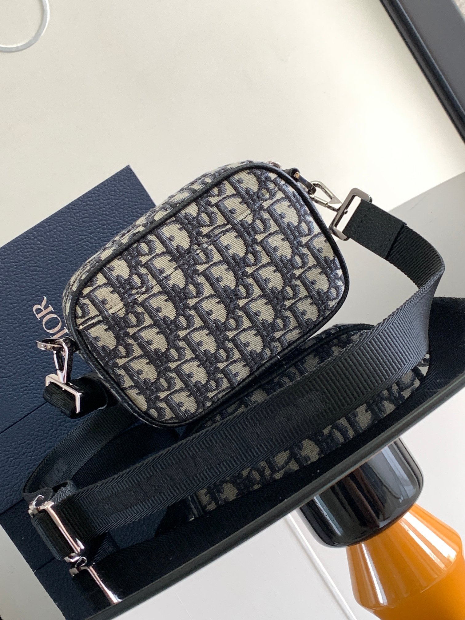 Dior Safari Messenger Bag Features & Materials: Main material: Beige and black Oblique print fabric Details: Black-grained calfskin leather accents Dimensions: 17 × 12.5 × 4 cm (L × H × W) Model number: 2ESWS011YKY_H27E 4 Dior Safari Messenger Bag Features & Materials: Main material: Beige and black Oblique print fabric Details: Black-grained calfskin leather accents Dimensions: 17 × 12.5 × 4 cm (L × H × W) Model number: 2ESWS011YKY_H27E - Image 4