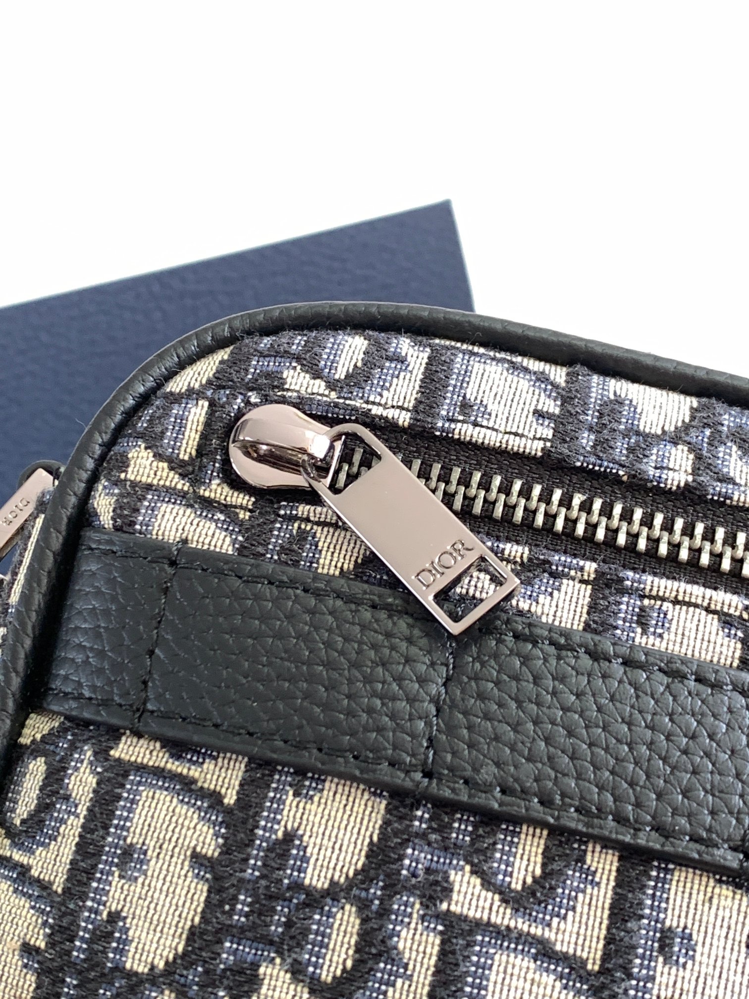 Dior Safari Messenger Bag Features & Materials: Main material: Beige and black Oblique print fabric Details: Black-grained calfskin leather accents Dimensions: 17 × 12.5 × 4 cm (L × H × W) Model number: 2ESWS011YKY_H27E 6 Dior Safari Messenger Bag Features & Materials: Main material: Beige and black Oblique print fabric Details: Black-grained calfskin leather accents Dimensions: 17 × 12.5 × 4 cm (L × H × W) Model number: 2ESWS011YKY_H27E - Image 6