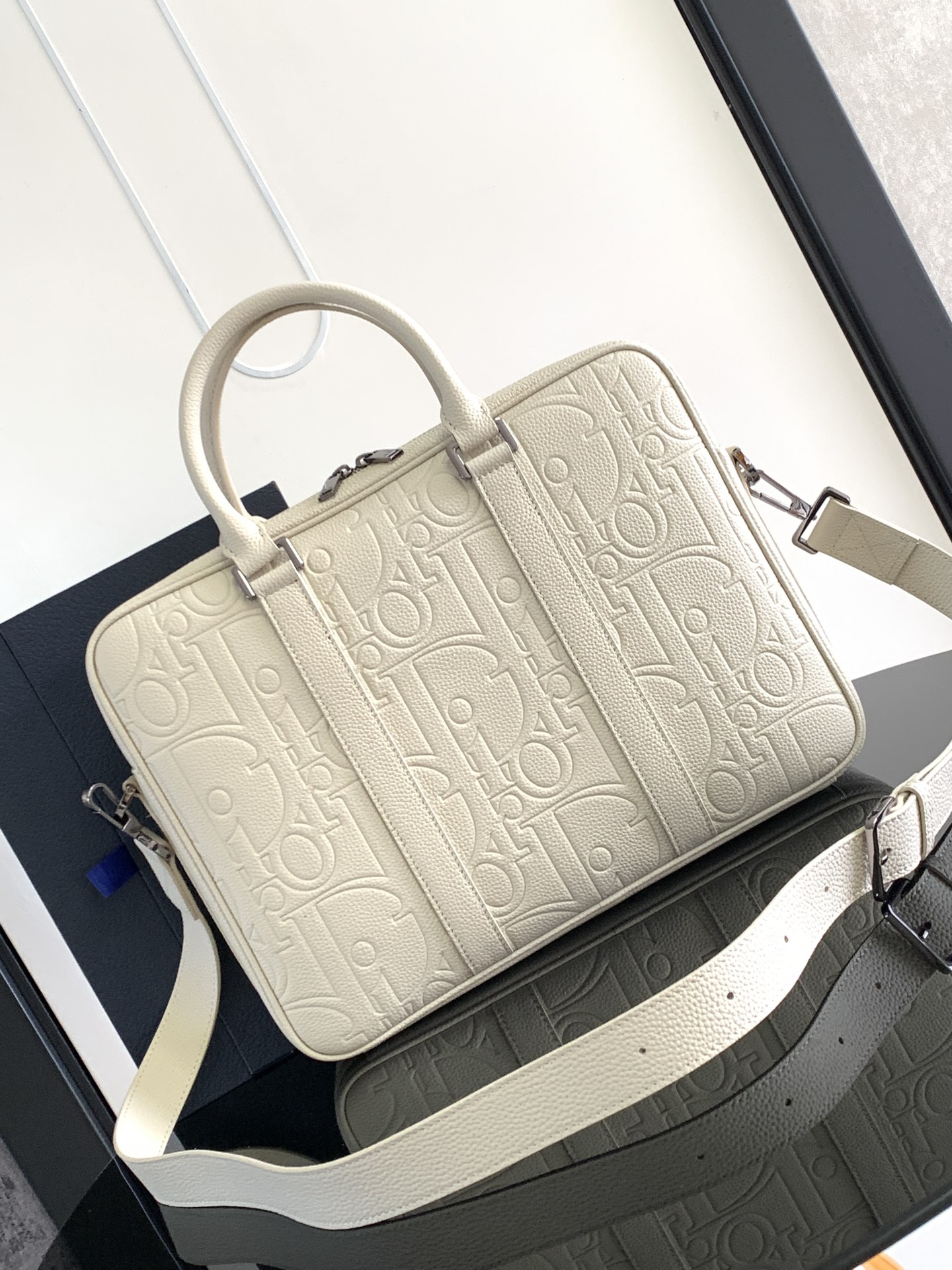 Dior Briefcase Main materials: Cotton, calfskin leather, and technical fabric Interior lining: Technical fabric, cotton, calfskin leather Dimensions: Size: 37 x 28 x 6 cm (L x H x W) Model number: 1ESBR180YKY_H03E 3 Dior Briefcase Main materials: Cotton, calfskin leather, and technical fabric Interior lining: Technical fabric, cotton, calfskin leather Dimensions: Size: 37 x 28 x 6 cm (L x H x W) Model number: 1ESBR180YKY_H03E - Image 3